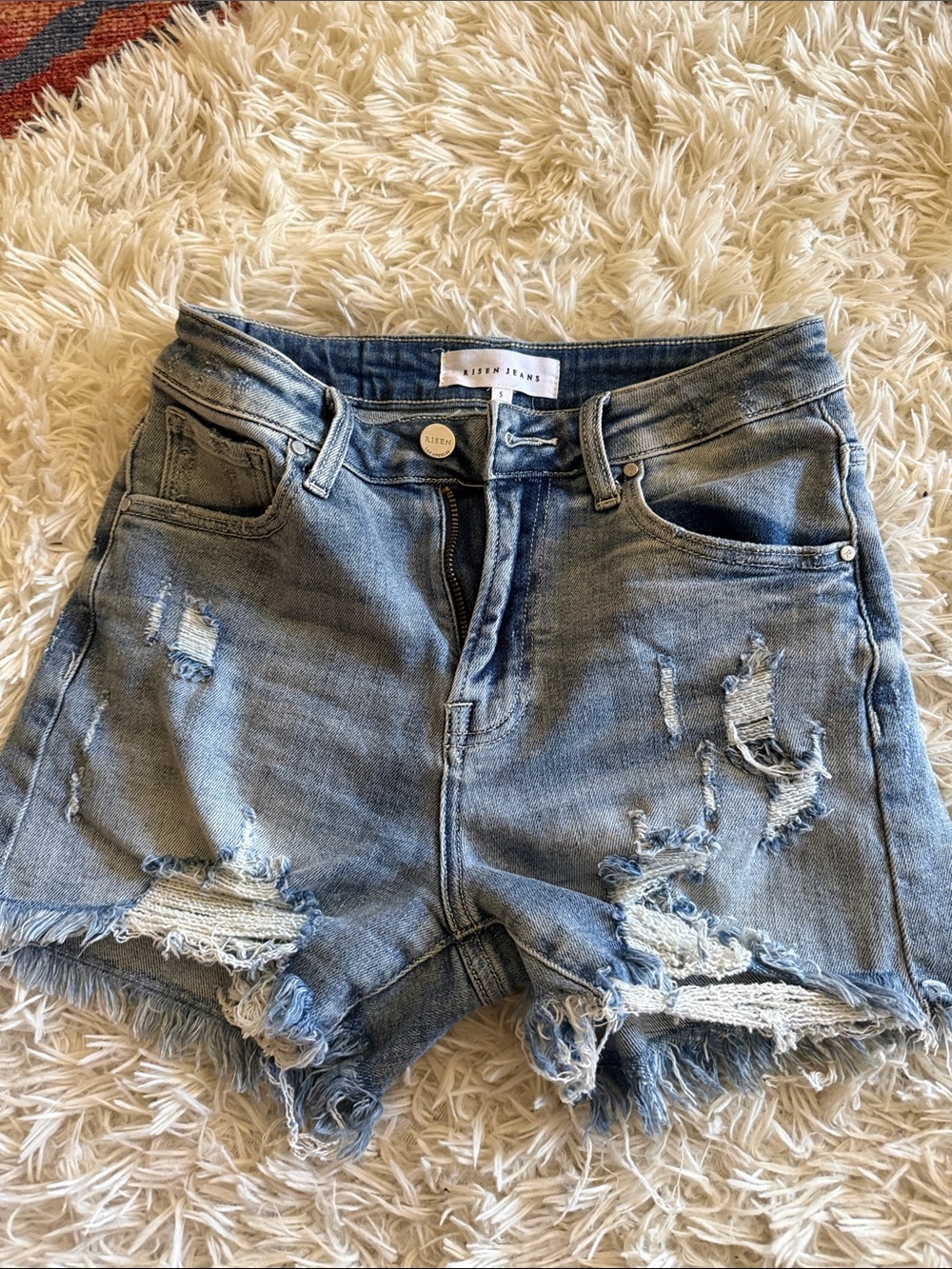 High-Rise Distressed Denim Shorts in Light Blue